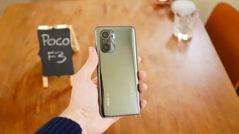 The Poco F3 in a hand.