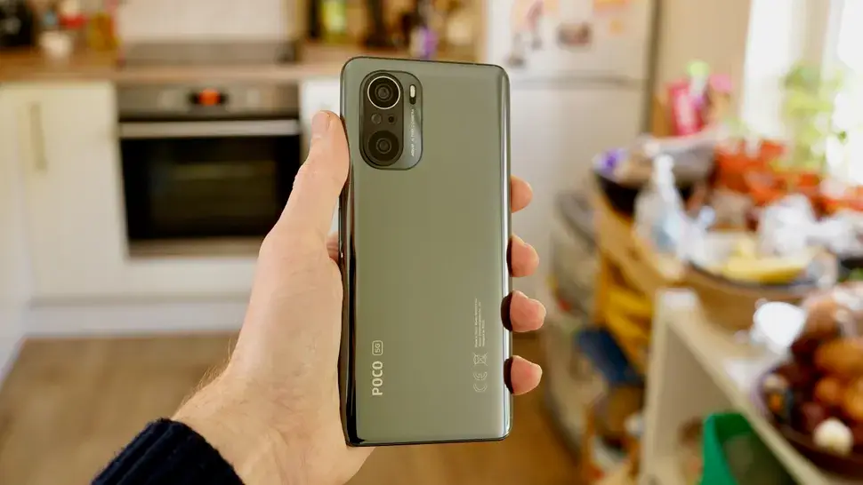 The Poco F3 in a hand
