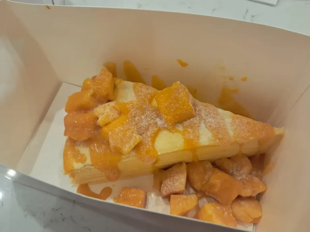 بررسی گوشی سامسونگ گلکسی ای 25 فایو جی 8 Mango cheesecake slice, photographed on the Galaxy A25.